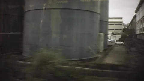 Riding on train view of construction building structure of industrial work zone  Stock Footage 237251770