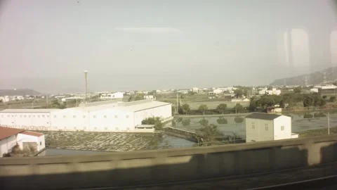 Riding on train view of construction factory storage residential neighborhood bu Stock Footage 237251864