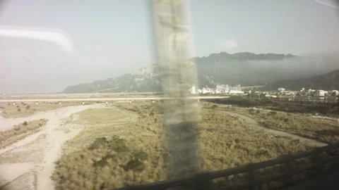 Riding on train view of a look out to the dry riverbed field with meadow light b Stock-Footage 237251858