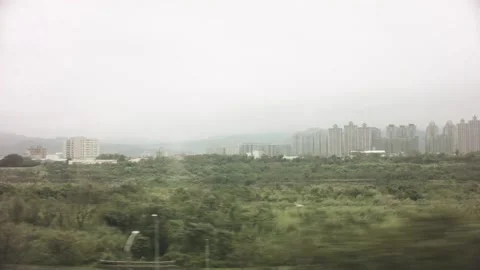 Riding in train view of passing by huge highway bridge underneath and cityscape  Stock Footage 237251741