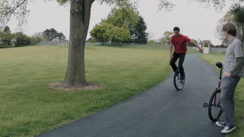 Riding a Unicycle Vídeos de archivo 90054649