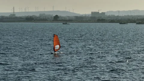 Riding the Waves of Joy: Aerial Perspective of Windsurfing Fun and Ocean Revelry Stock Footage 255978278