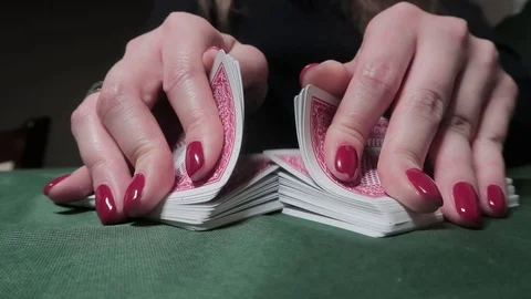 Riffle Shuffle. Close-up of woman's hands shuffling cards on green cloth 動画素材 125099697