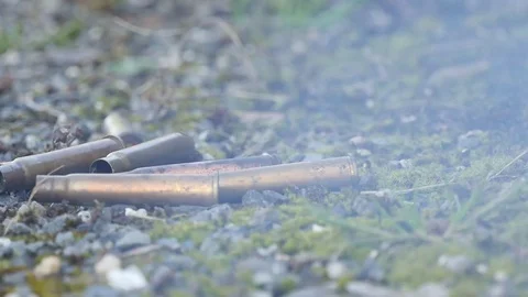 smoking bullet casing fired out of a handgun falling down Stock