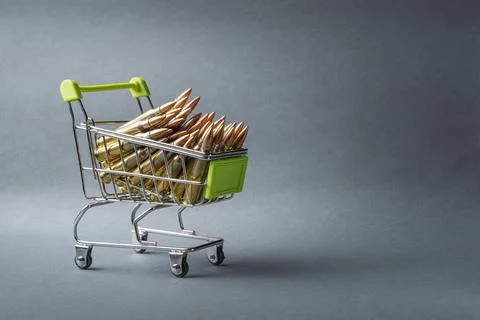 Rifle cartridges in a shopping cart. 223 caliber ammo cartridges and a small Stock Photos