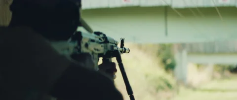 Rifle ejects shell casing as man fires during outdoor firearm training session Stock Footage 311902773