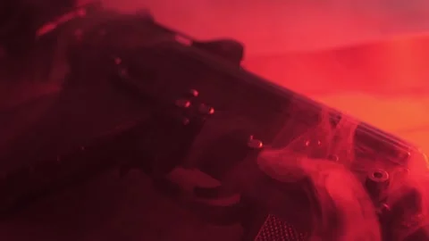 A rifle is lying on the table, close-up. smoke from gunshots. Stock Footage 206058912