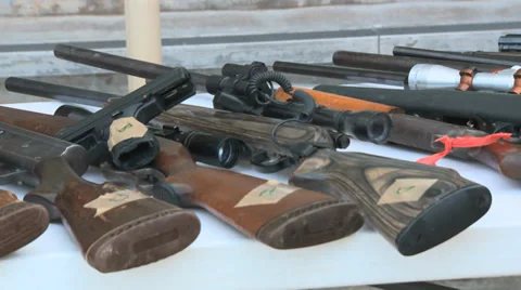 Rifles and guns on table Stock Footage 33280297