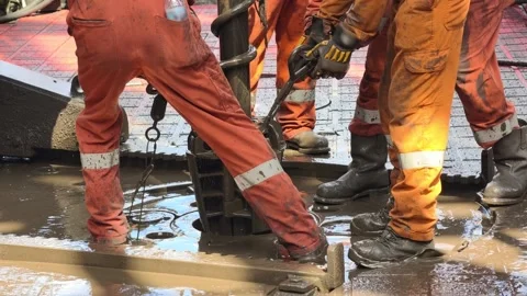 Rig crew perform pulling of of hole drill string with oil based mud Stock Footage 342082010