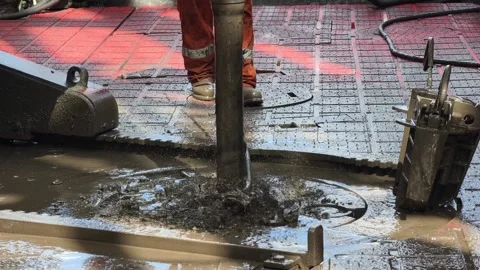 Rig crew perform pulling of of hole drill string with oil based mud Stock Footage 342082062