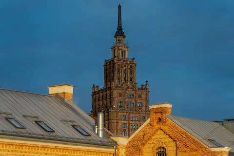 Riga Academy of Sciences tower and old brick rooftops Stock Photos