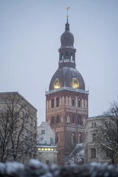 Riga Cathedral tower with a clock and the cock of the Cathedral tower. Stock Photos
