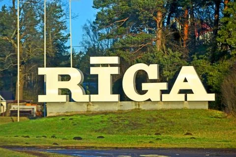 Riga city invitation text message on foirest backjground, Latvia. Stock Photos