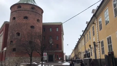 Riga, Latvia, A large brick building with a clock tower in the middle of the Stock Footage 134419238