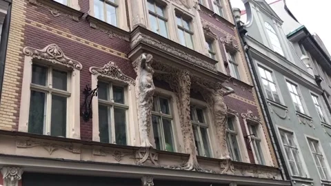Riga, Latvia, A large brick building with a clock on the front of a window Video stock 134419783