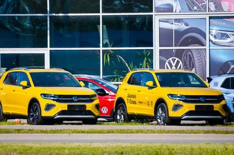 Riga, Latvia - May 17, 2024: New yellow Volkswagen cars in the background of  Stock Photos