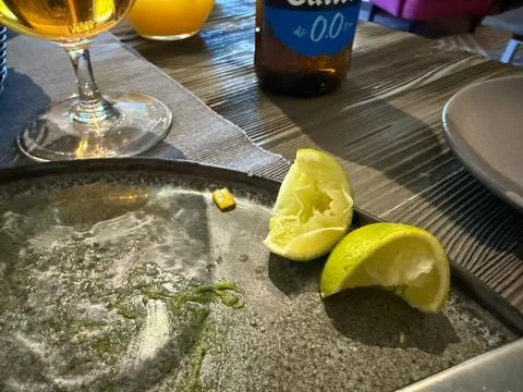 Riga, Latvia - May 2, 2026:Empty Restaurant Plate with Lime Wedges and Drinks Stock Photos