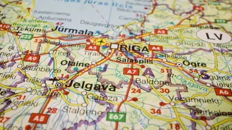 Riga, latvia road network leading to the capital, gliding over atlas map Stock Footage 340106740