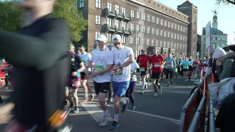Riga Marathon 2023 runners run towards start line Stock Footage 240538514