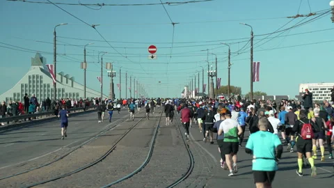 Riga Marathon 2023, runners run thru Akmens Bridge Stock Footage 240538519