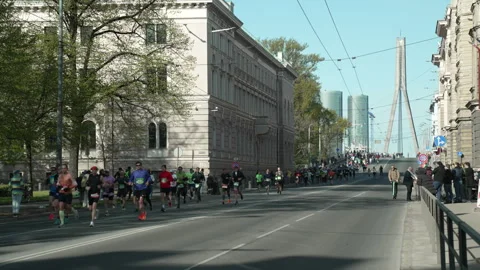 Riga Marathon 2023, runners run down the Vansu Bridge Stock Footage 240538699