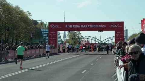 Riga Marathon 2023, runners run towards finish arch. Stock Footage 240538963