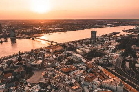 RIga rooftop view panorama at sunset with urban architectures and Daugava Riv Stock Photos