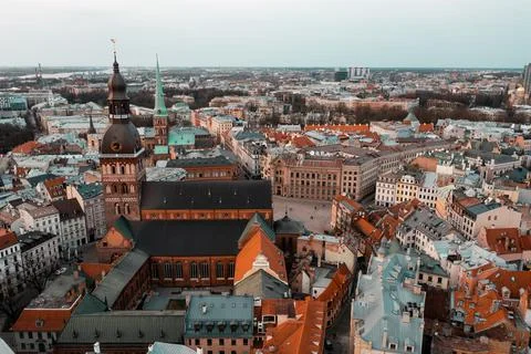 RIga rooftop view panorama at sunset with urban architectures and Daugava Riv Stock Photos