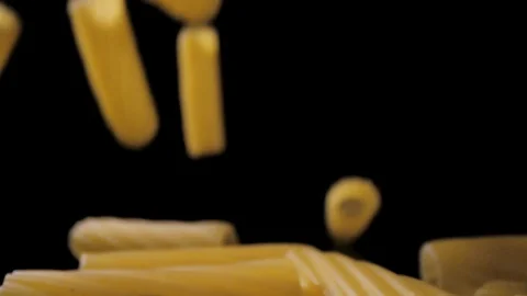 Rigatoni Pasta Falling Down black background, slow motion Video stock 112447390