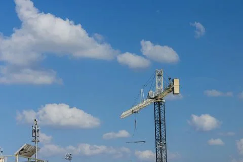 Rigger crane at construction site structural steel large residential building Fotos de archivo
