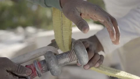 Riggers' Hands Securing Shackle With Clevis Pin. close up Stock Footage 171537555