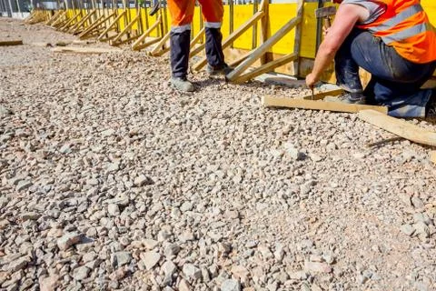 Riggers, workers are assembly long mold for concreting Stock Photos