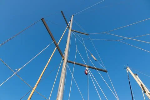 Rigging mast and halyards of a sailing boat under a beautiful blue sky Stock Photos