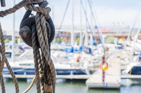 Rigging on the old sailboat against the background of modern yac Stock Photos