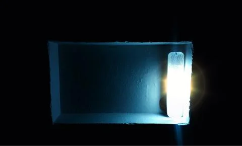 Right aligned glowing lamp in rectangular hollow background Stock Photos