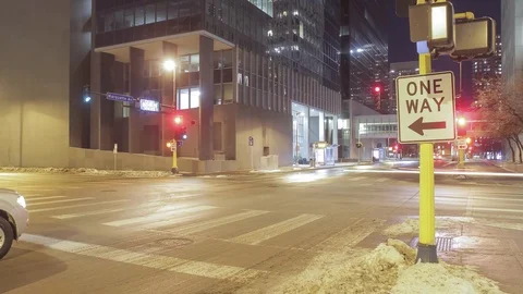A Right Aligned One Way Sign and Downtown Night Traffic Stock Footage 85574071