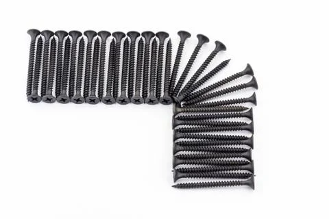 A right angle of frame laid out by black avarage screws on white background Stock Photos