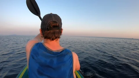Right behind shot: Man paddling his kayak at sea Stock Footage 112253344