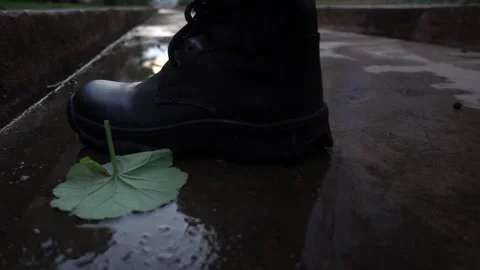 Right foot in boot steps in the puddle Stock Footage 146466214