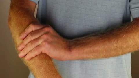 Right Forearm of a Man Being Self Massaged by His Left Hand Close-up Stock Footage 202051731