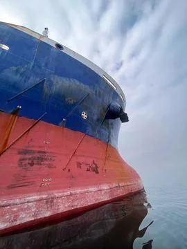 Right front side of a large red-blue ship at sea close-up 스톡 사진