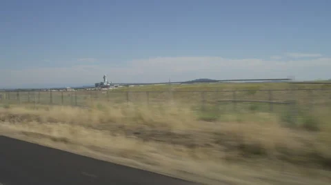 Right Front Three Quarter view of a Driving Plate: Car travels east along the Stock Footage 59314151
