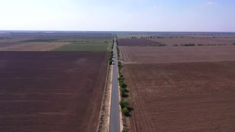 Right geometric view on the road right between two fields Stock Footage 151309508