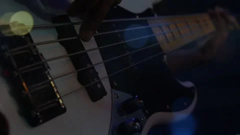 Right hand approaching pickups, starting plucking and muting bass strings, Video stock 330981054