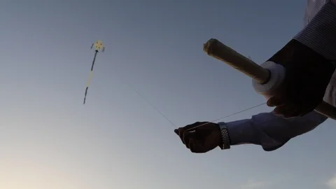 Right hand flying kite by balancing string and left hand holding the Stock Footage 126214269