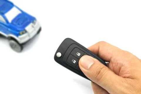 Right hand holding remote control car key for business concept Stock Photos