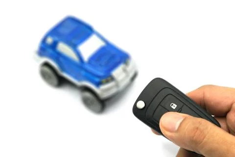 Right hand holding remote control car key for business concept Stock Photos
