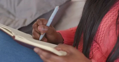 Right hand is lowering blue pen, pen tip touching notebook and writing notes on Stock Footage 344681979
