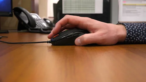 The right hand moves the computer mouse to the desktop Stock Footage 111582784