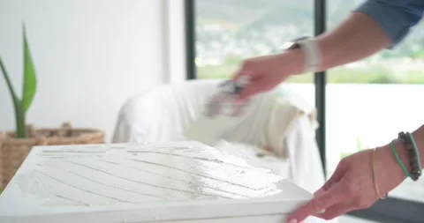 Right hand is picking up putty knife, spreading compound on panel near window, Stock Footage 339272153